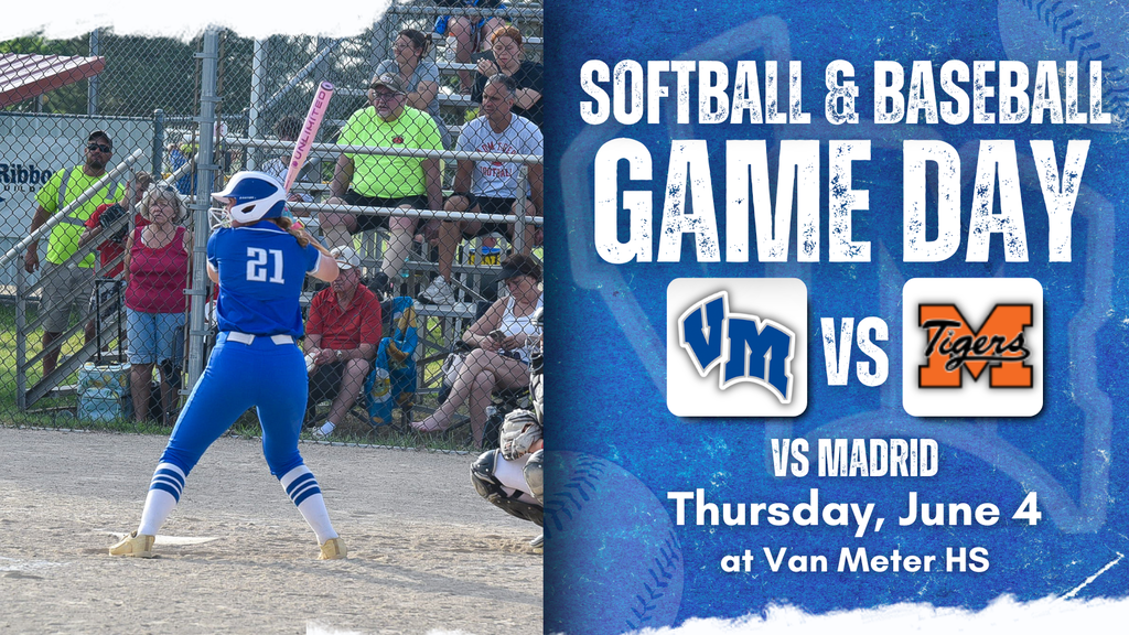 Softball player in blue uniform preparing to bat during a game with spectators behind the fence.