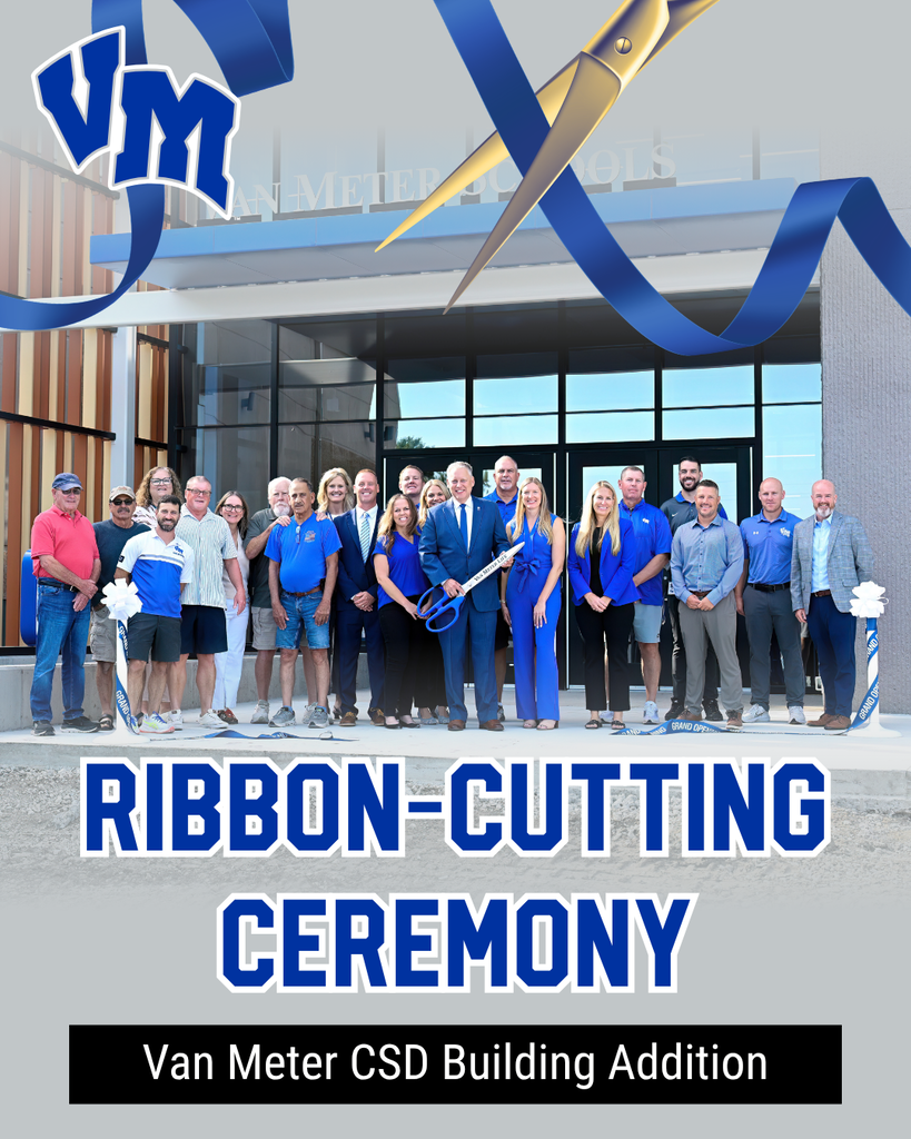Group of people gathered outside a modern building for Van Meter CSD ribbon-cutting ceremony with large scissors and blue ribbon overhead.