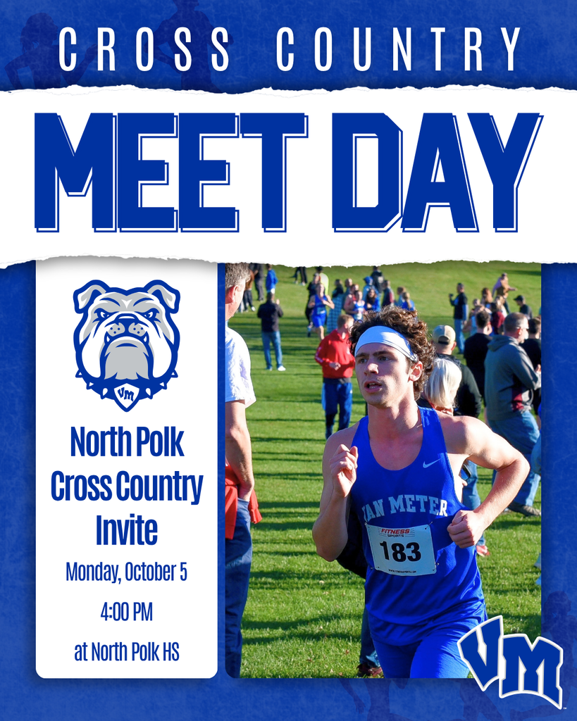 Runner in blue Van Meter uniform competing in a cross country race on a grassy field with spectators in the background.