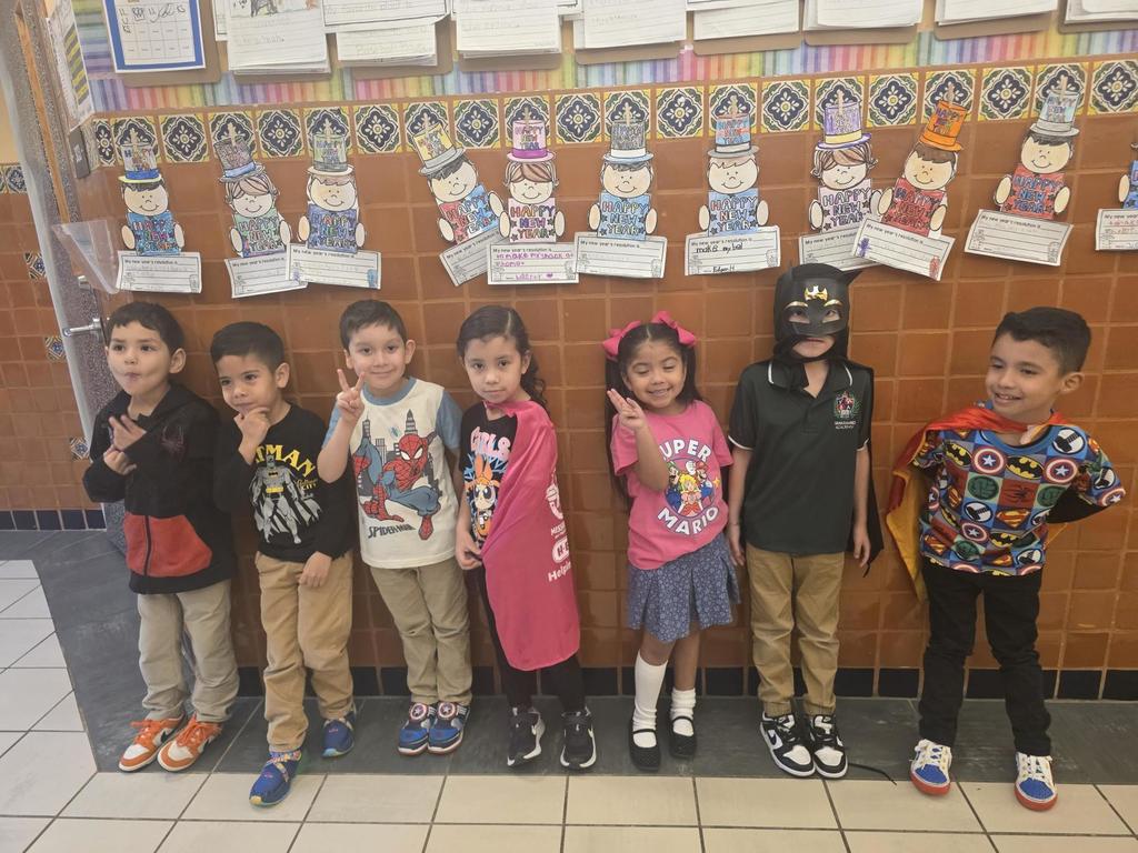 Seven students wearing super hero outfits.