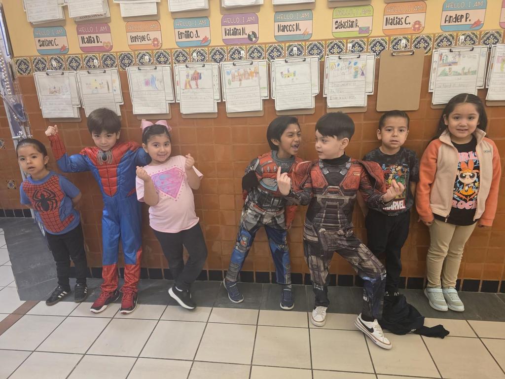 Seven students wearing super hero outfits.