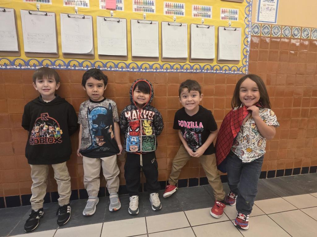 5 students in a line wearing superhero shirts