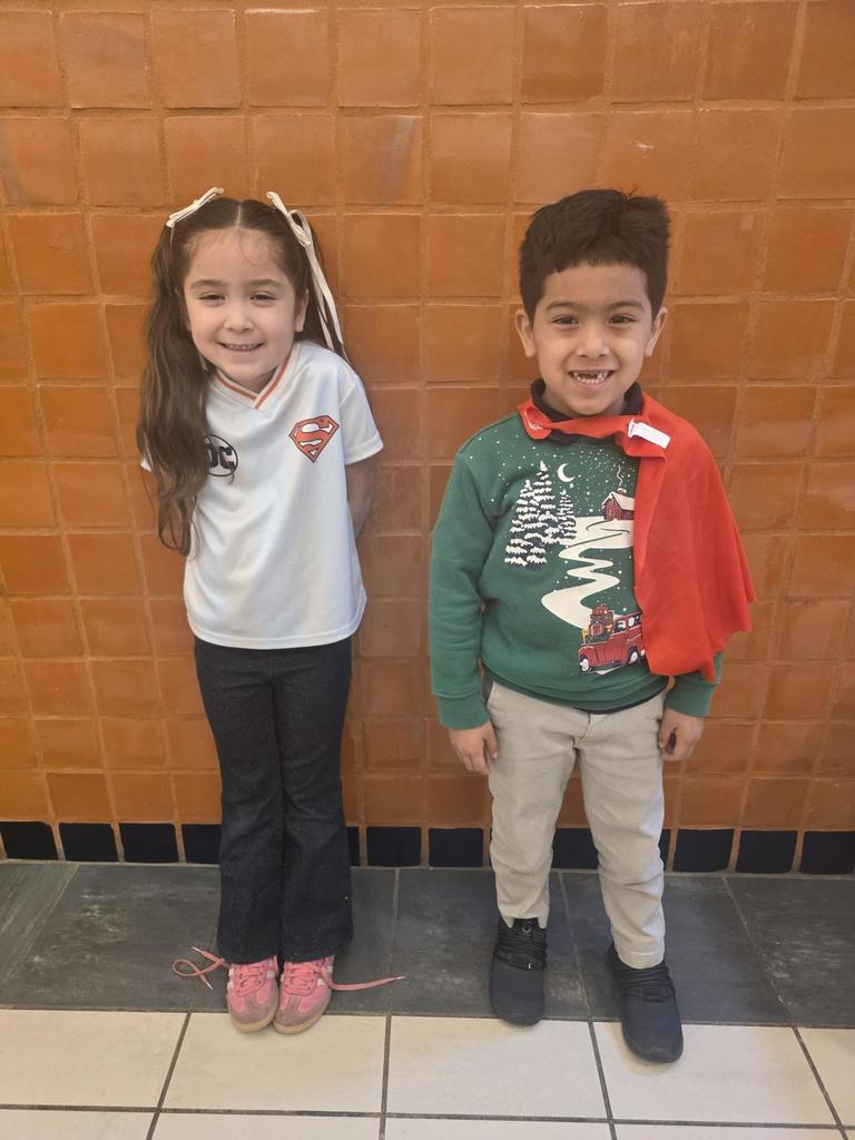 two students wearing super hero outfits.