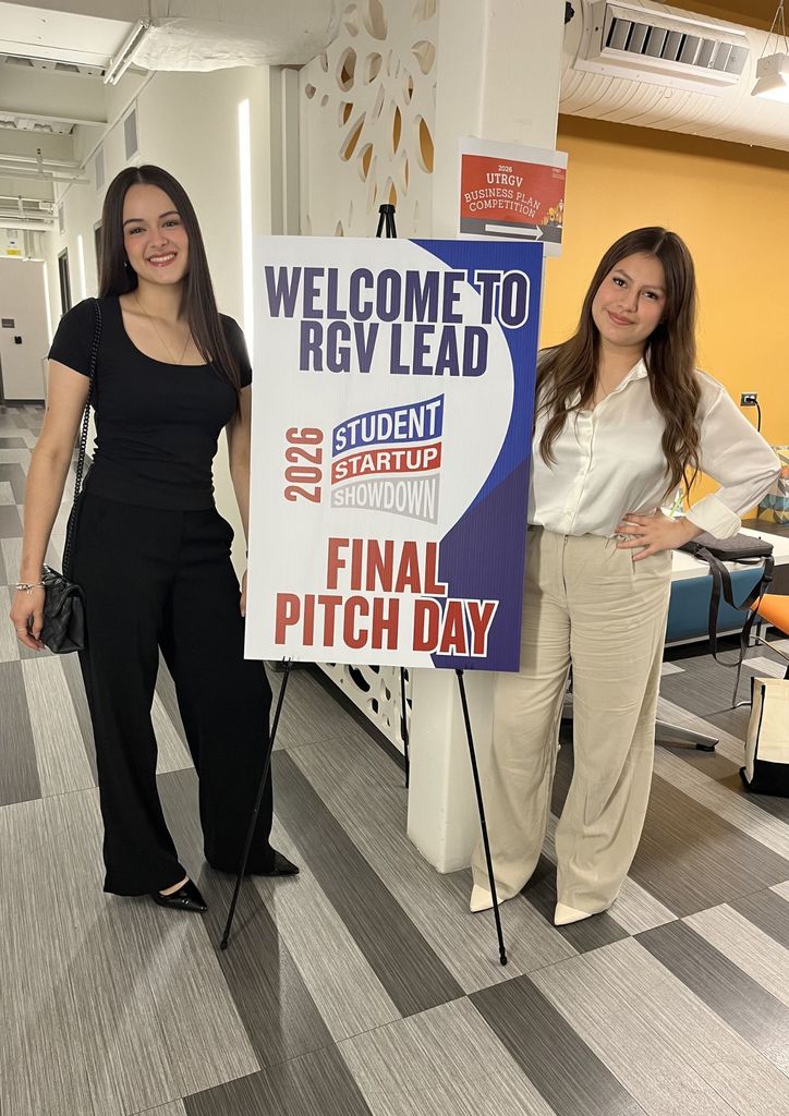 Two women pose next to a banner reading "Welcome to RGV Lead Student Startup Final Pitch Day 2026."