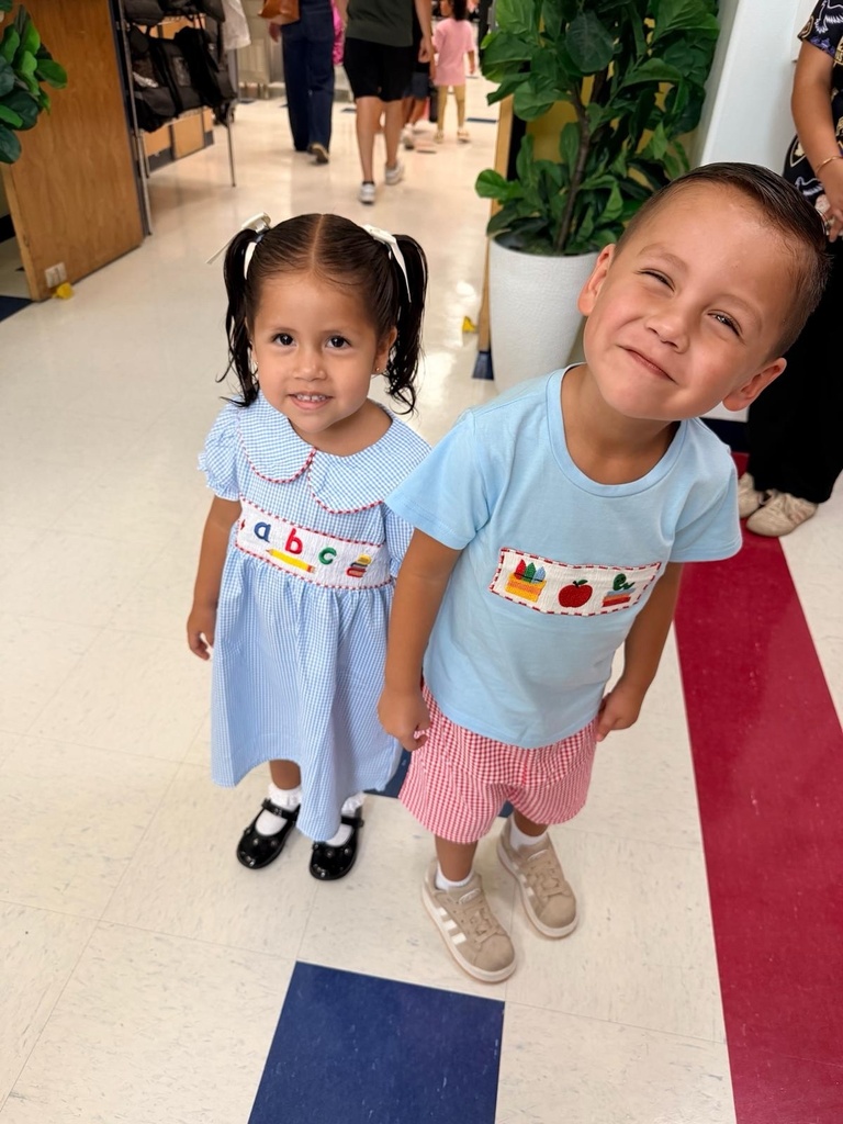 Two children smiling at the camera 