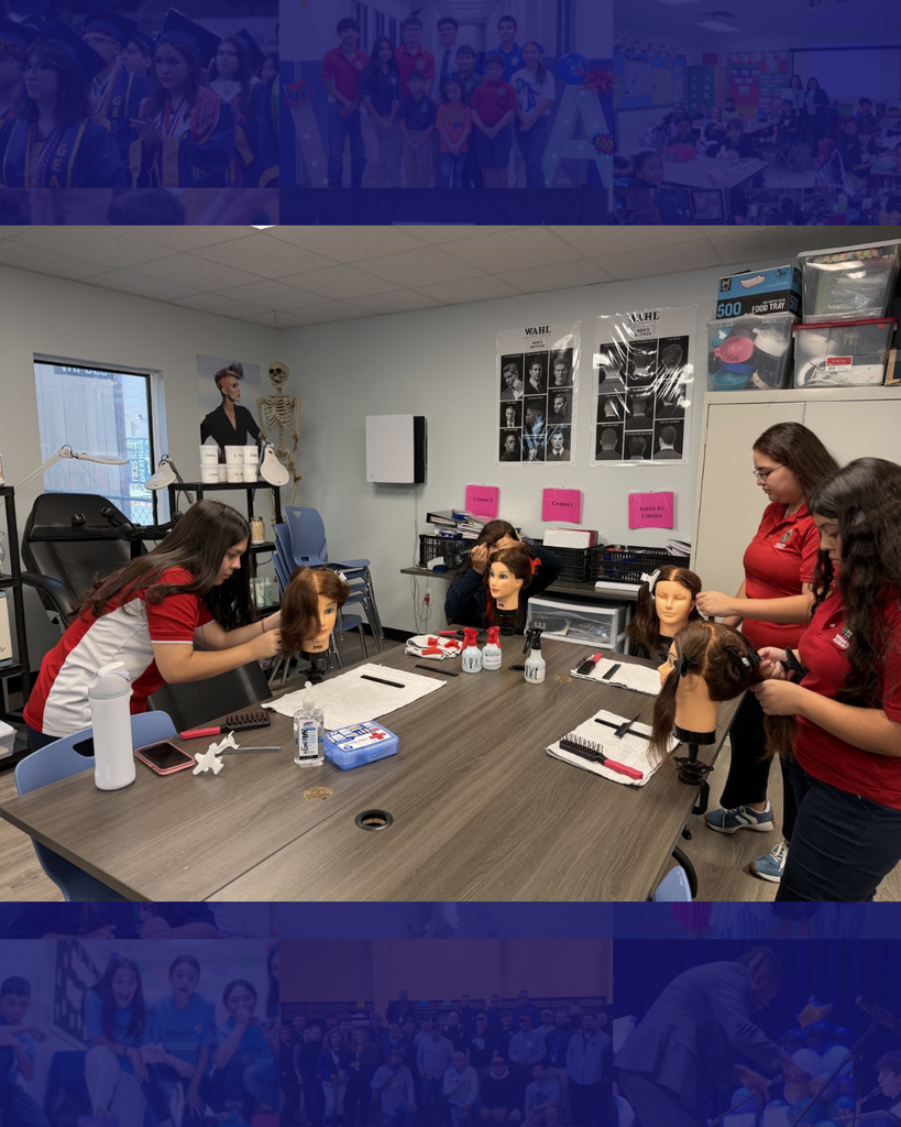 Several people in red shirts are styling mannequin heads with products at a table in a classroom.