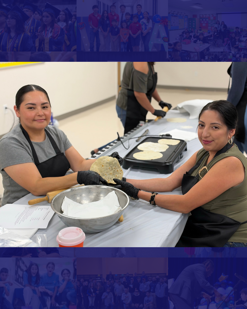 Two women wearing aprons and gloves prepare food at a table. One holds a rolled tortilla while the other flips tortillas on a griddle.