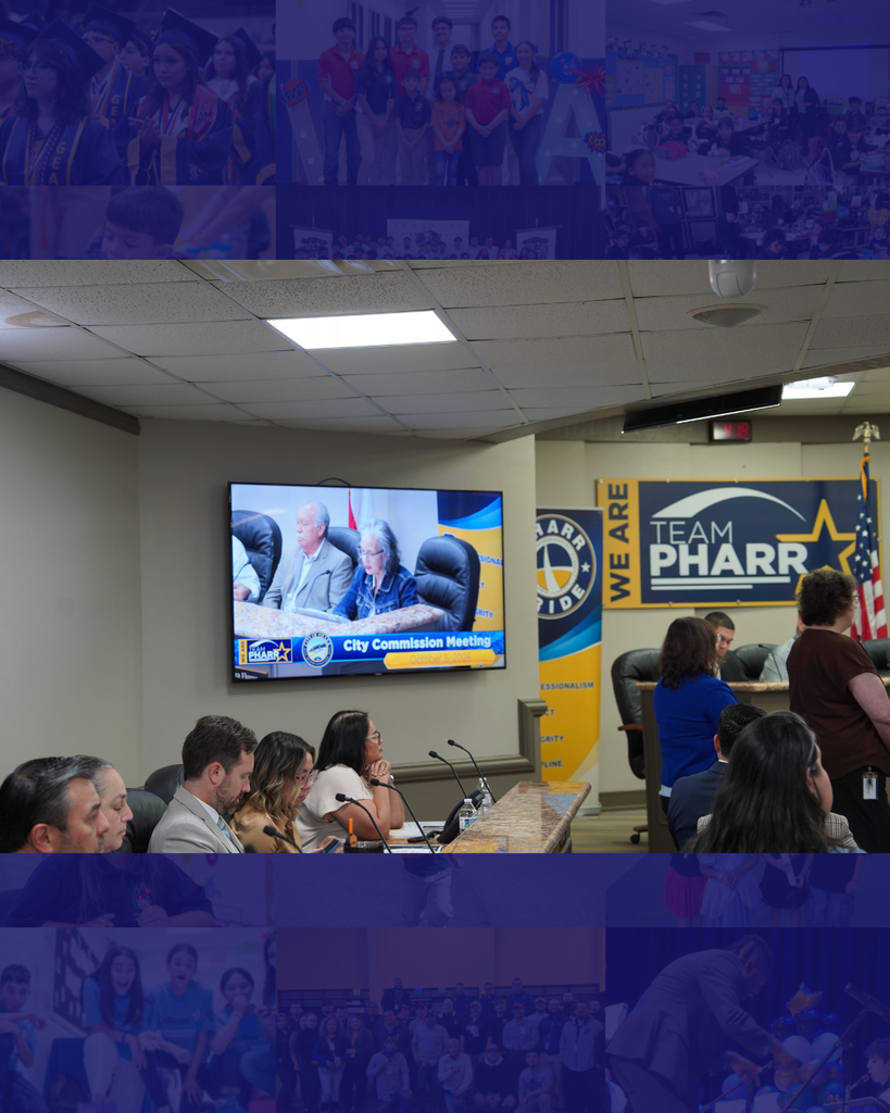 A meeting with a large group of people, a monitor displaying a man speaking, and a yellow sign with the text "TEAM PHARR".