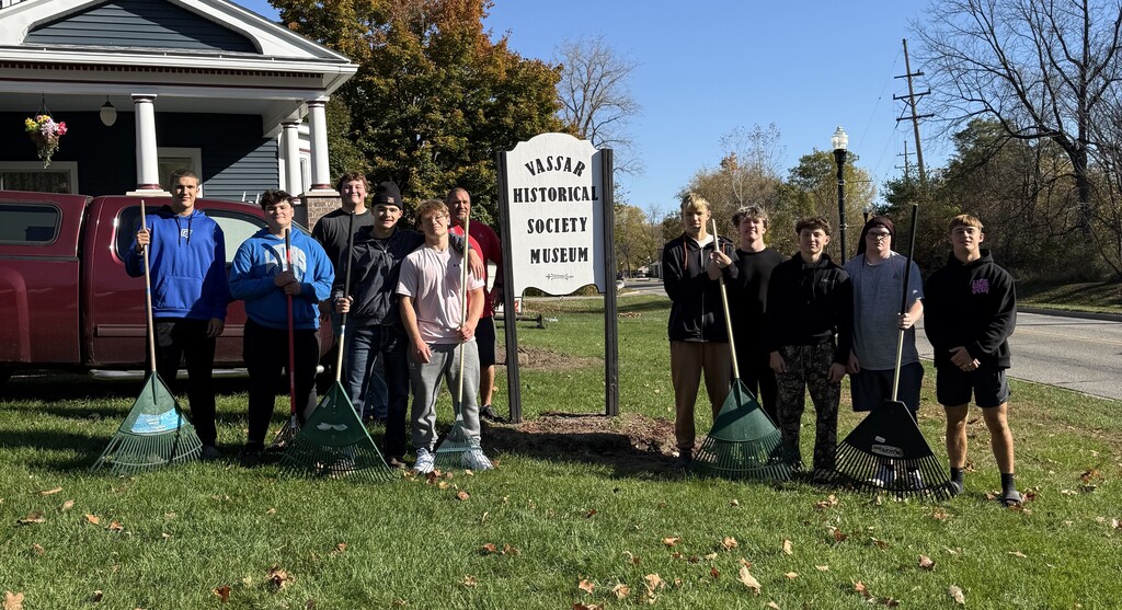 Football team raking at the Historical Society Museum