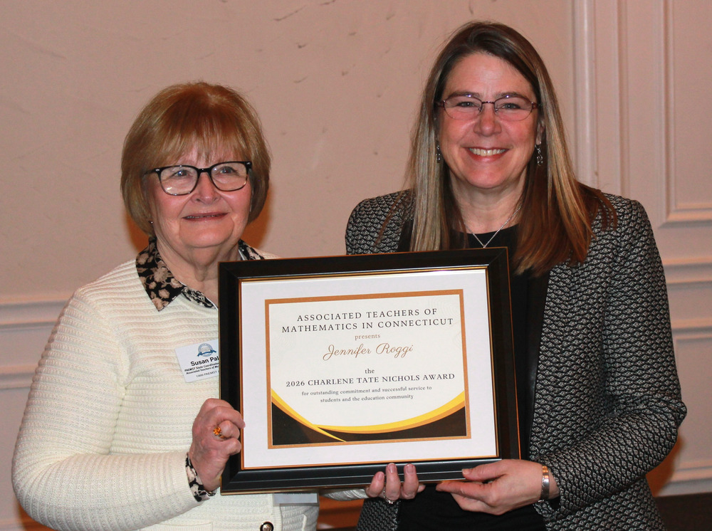 Jennifer Roggi, right, a math teacher at Vernon Center Middle School receoves an award.