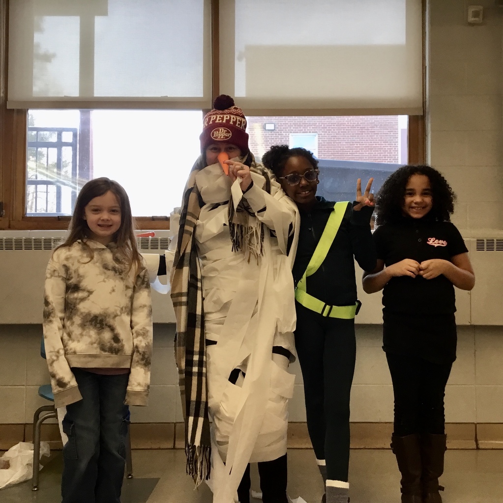 Final snow man with students who wrapped