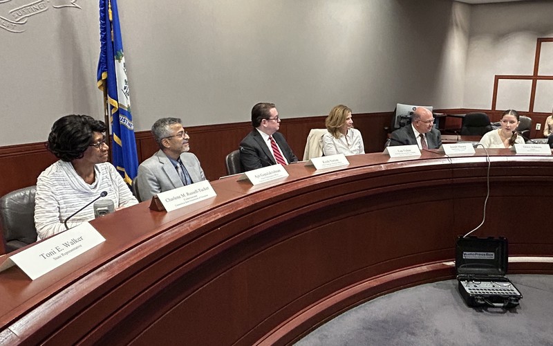 The education commissioner listens to Rockville High School senior Grace Johnson