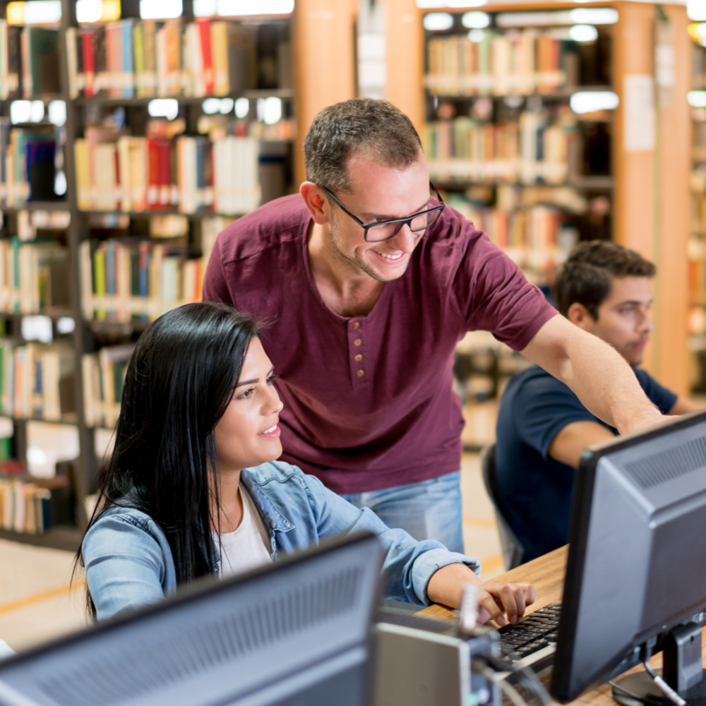 School employee helping parent at computer