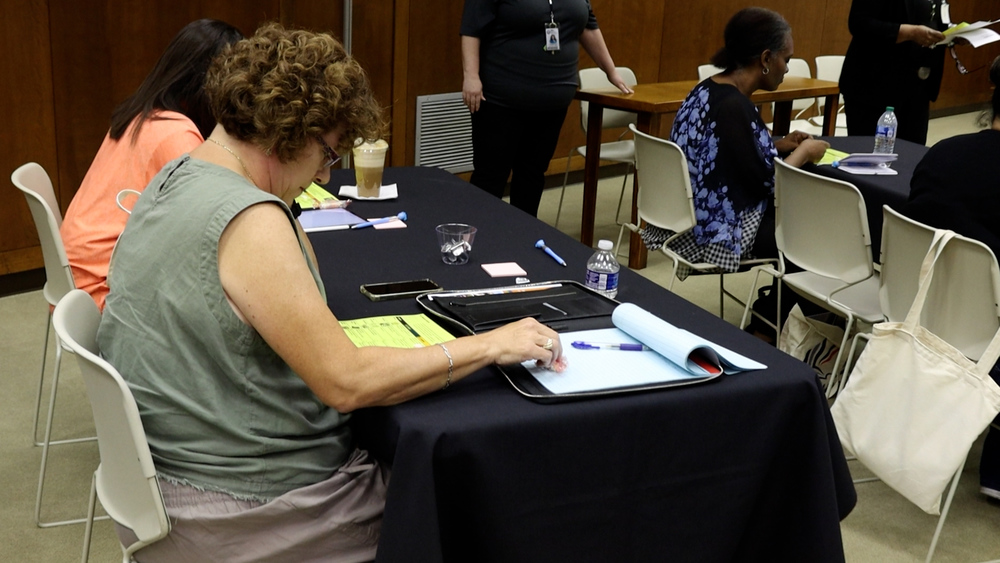 people sitting at table reading