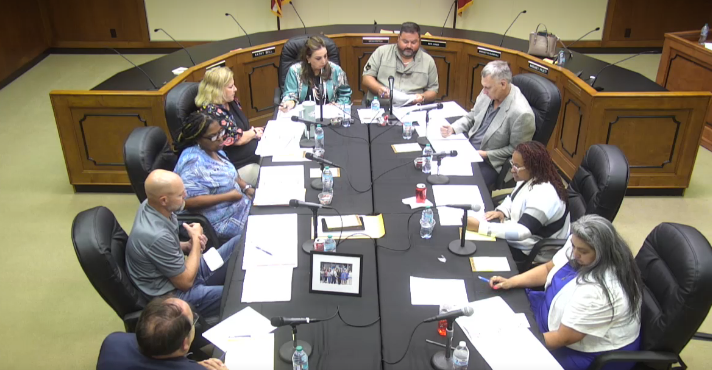 VISD Board of Trustees, Ms. Collazo, and Randall Meyer sitting around  table during Special Called Board Meeting 
