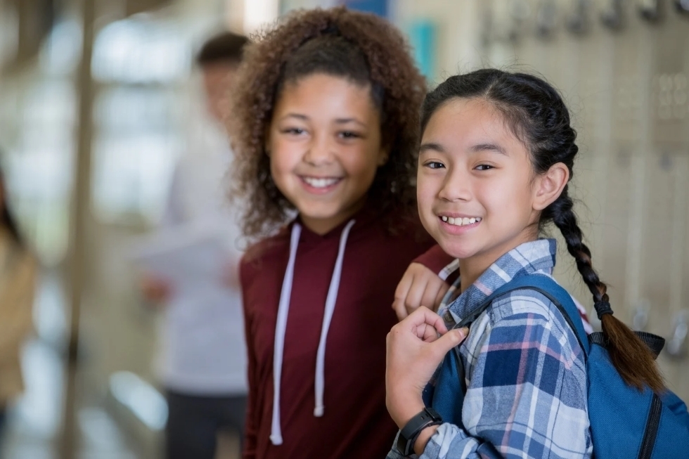 children smiling in hallway