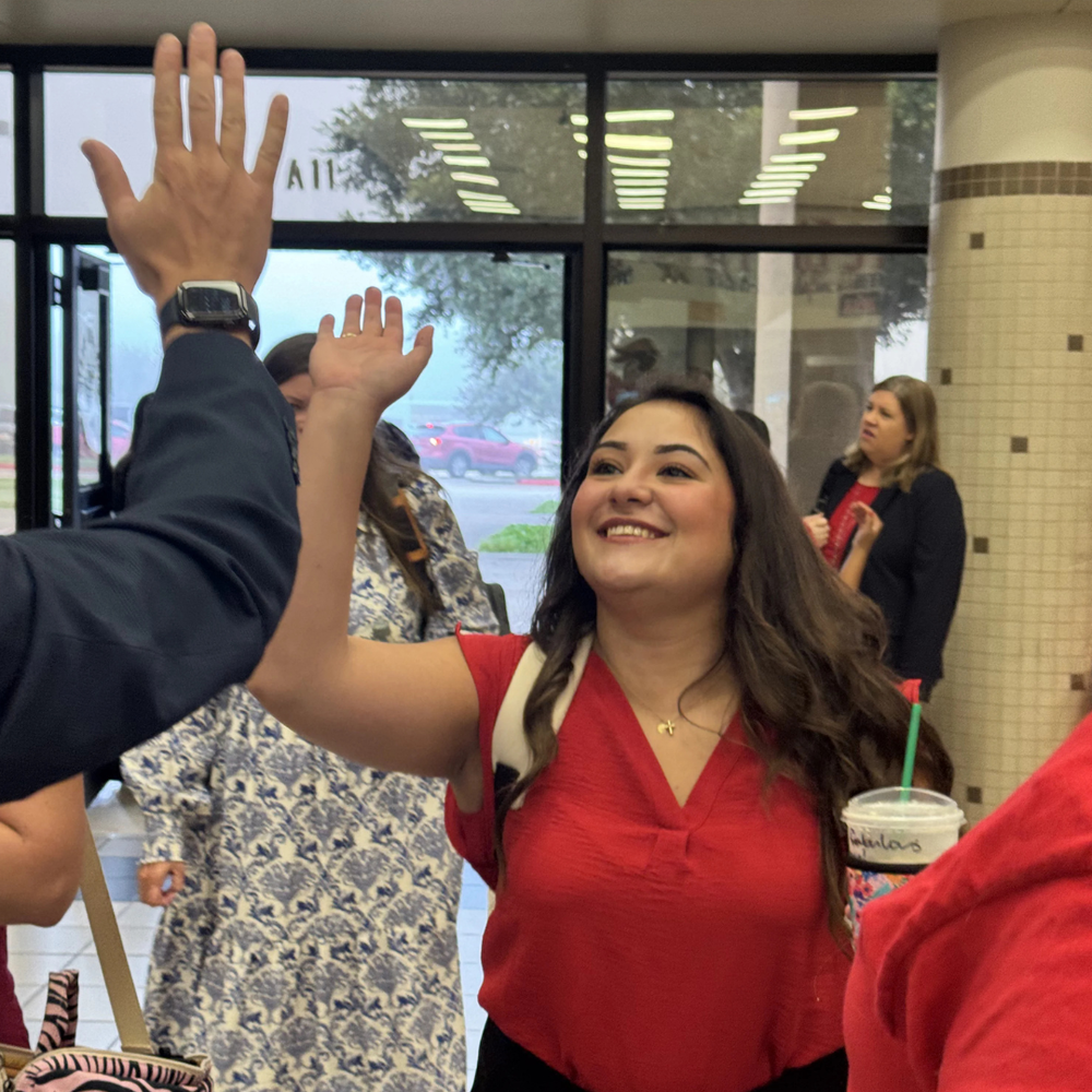 photo of new employee giving a high five