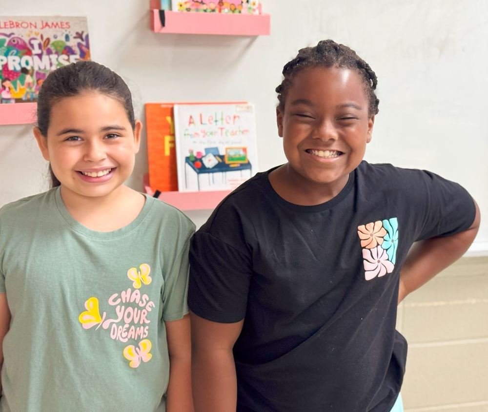 Two young girls smiling happily