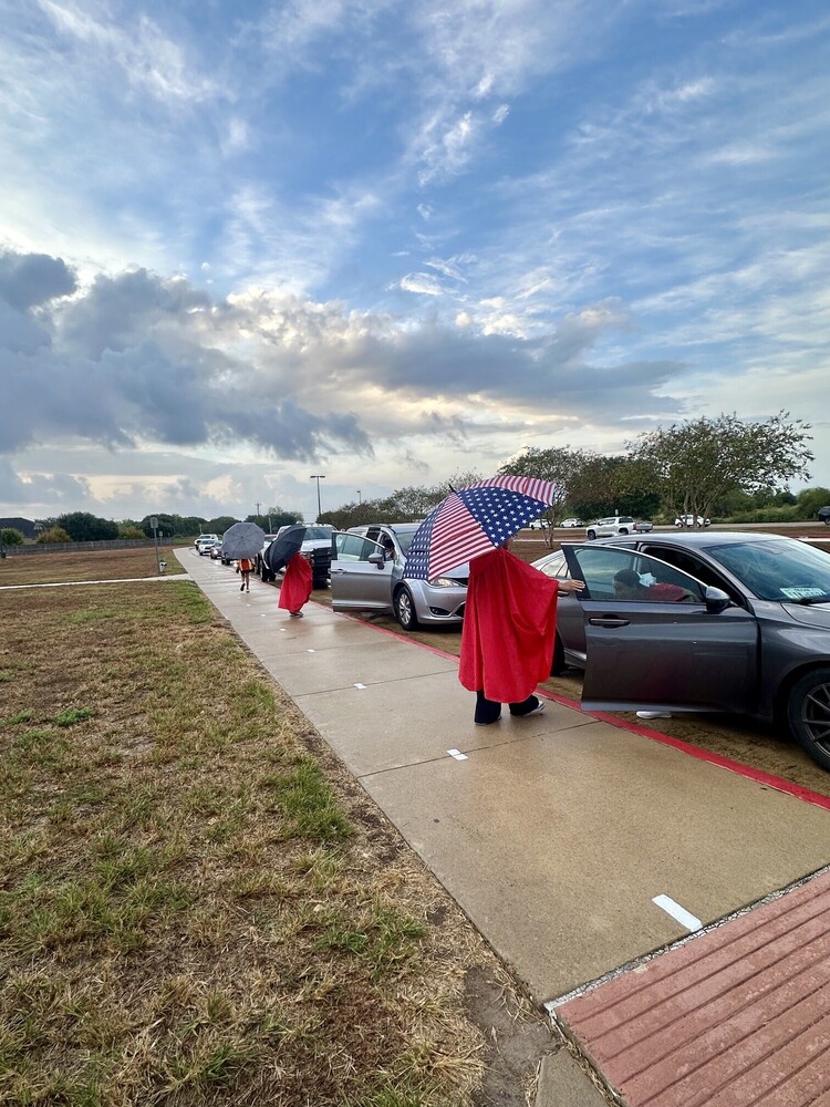 Students helping others in the rain