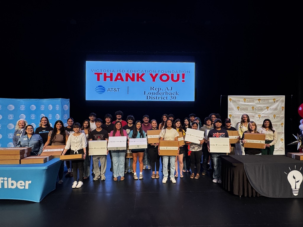 Victoria students, community representatives, and Victoria ISD Education Foundation members gather together with their new laptops  on the July 9 distribution.