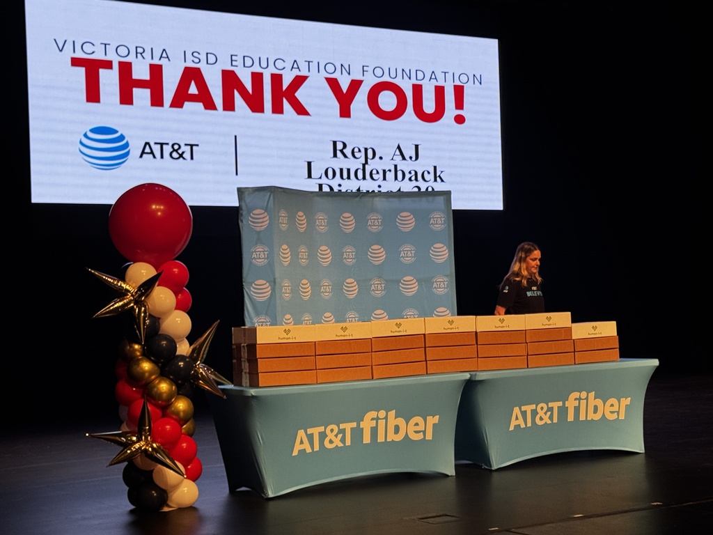 Thank you projection screen from the Education Foundation, with the laptops displayed on an AT&T table before distributing to students.  