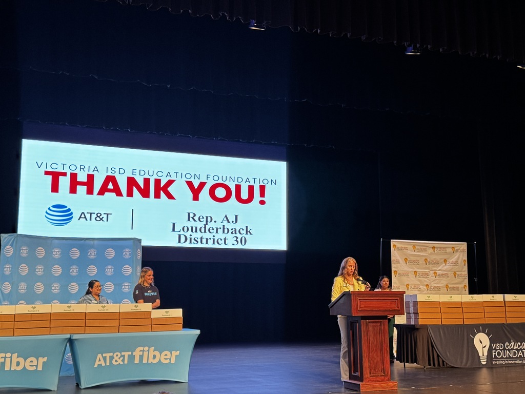 Victoria ISD Education Foundation President Pamela Orsak speaks to students and guests before the laptop distribution.