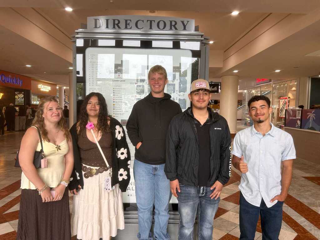 Students posing in front of some of their favorite spots on the senior trip!