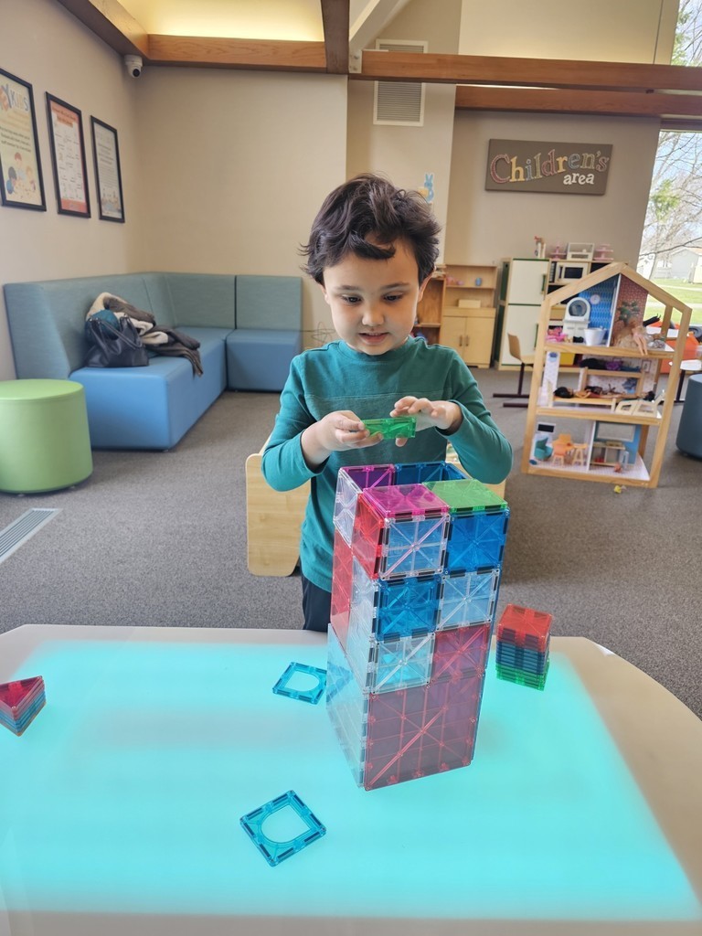 Kid building with Magna-tiles