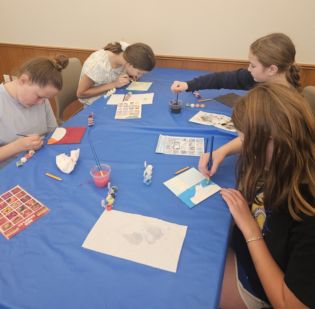 Kids painting mural tiles