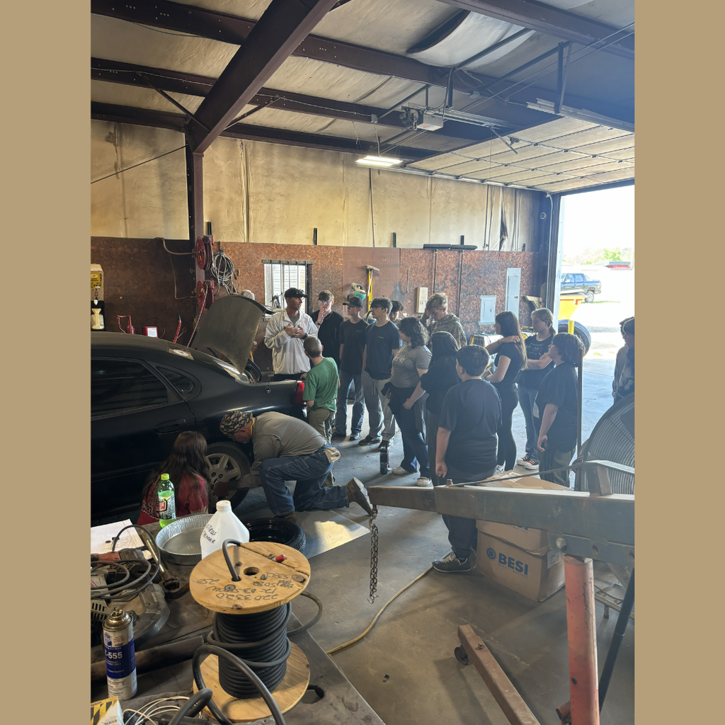 Students learn basic car mechanics.