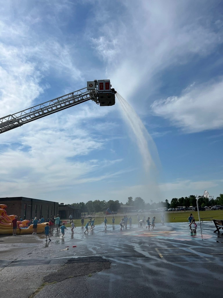 Firetruck spraying water on playground