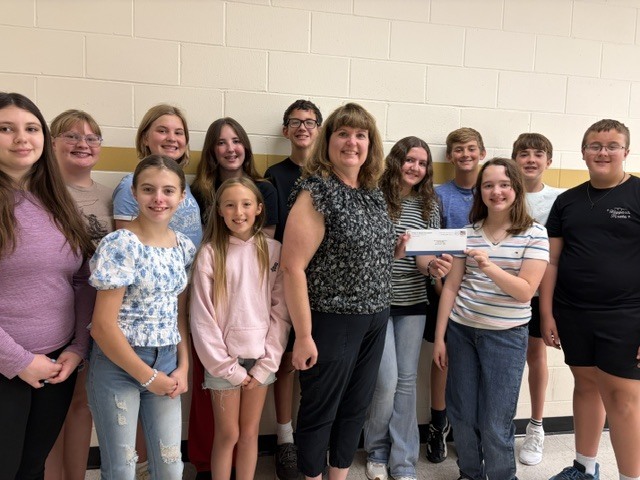 A few members of the MCJHS music department accepting a Grant check