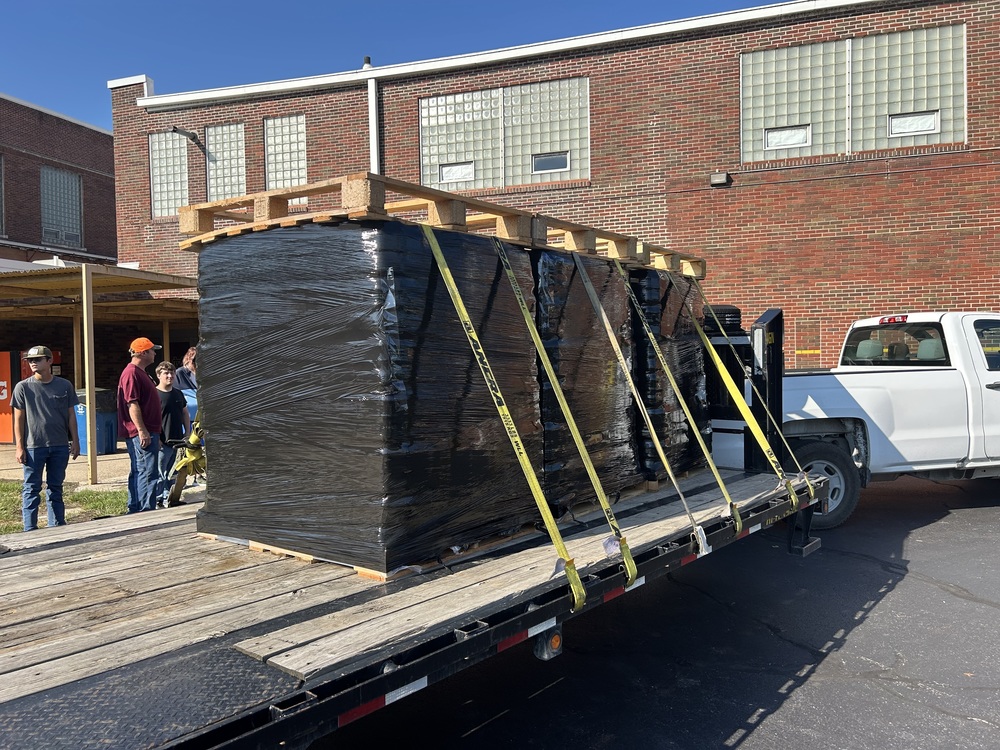 Pallets of water on bed of truck