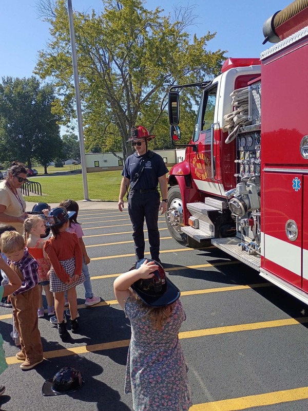 Preschool examine a MCFD fire engine.