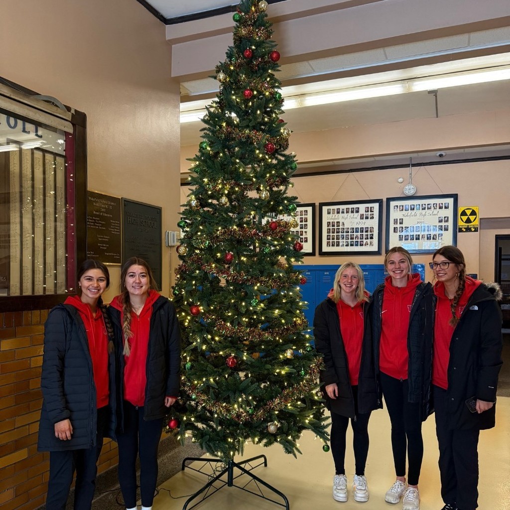girls by christmas tree