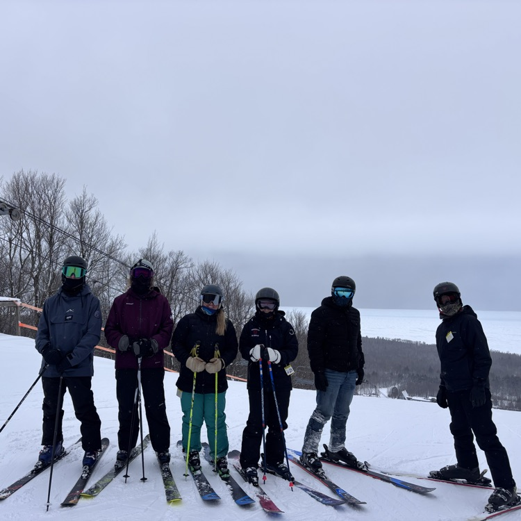 students and teacher skiing
