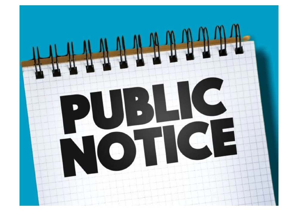 spiral notebook ontop of a blue background with the words Public Notice written across the notebook