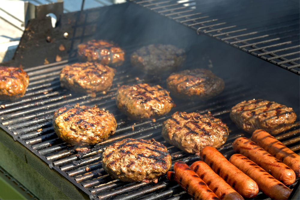 Graphics of a grill with hot dogs and hamburgers cooking