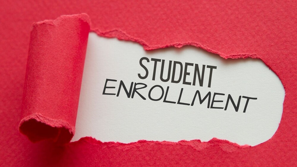 ripped red folder with the words Student Enrollment underneath