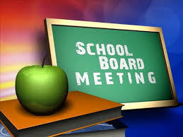 a green chalkboard that says School Board Meeting, with a green apple in front of it sitting on top a stack of books