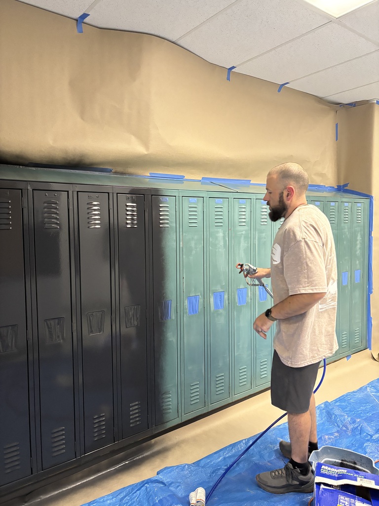 Graphics of Mr. Nason spray painting the middle school lockers black