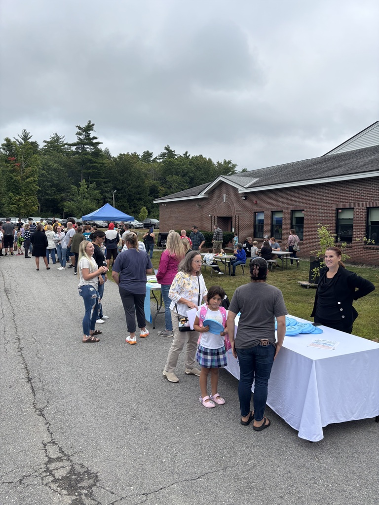 A picture of families at the Wakefield BBQ, standing outside talking