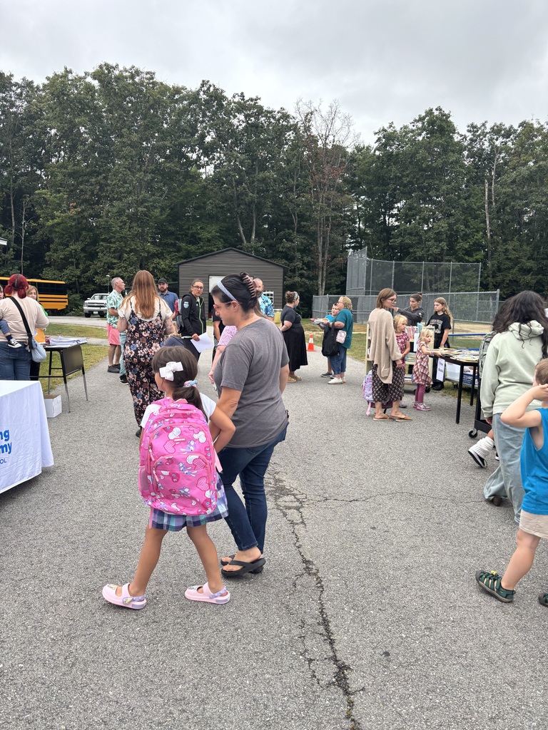 A picture of families at the Wakefield BBQ, standing outside talking