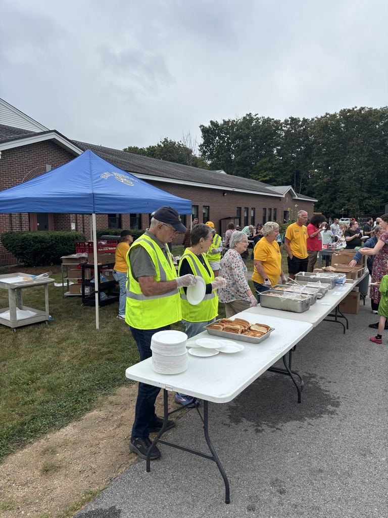a picture of the lions club members serving the BBQ