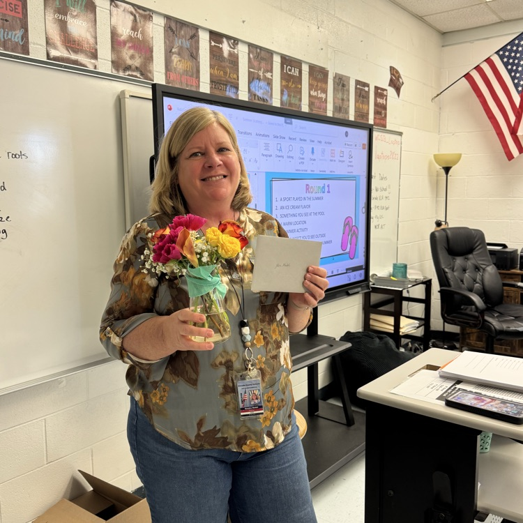 Ms. Maddi holding flowers Wakulla High’s September of the Month Teacher of the Month