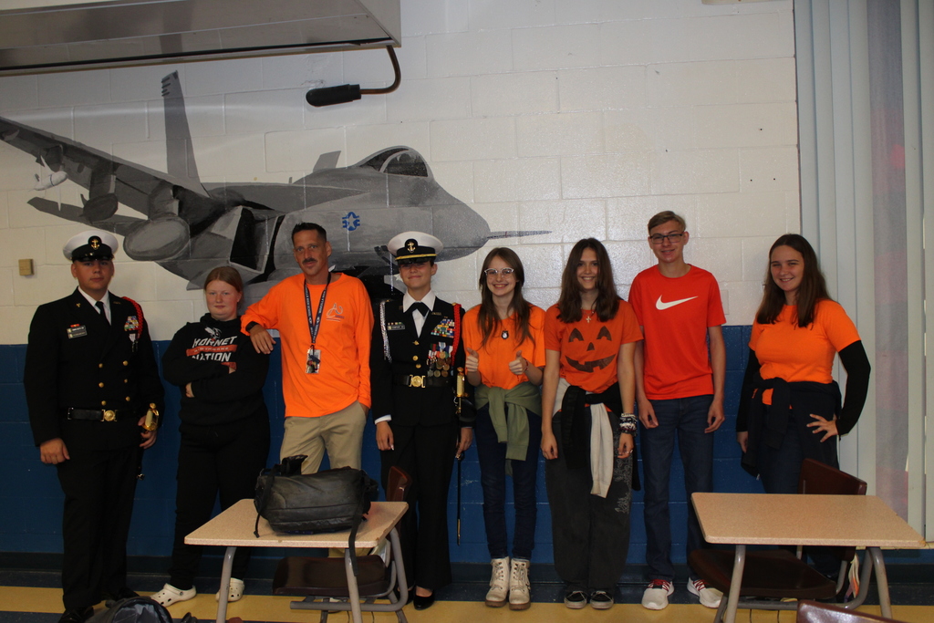 orange day, uniforms, jet on wall