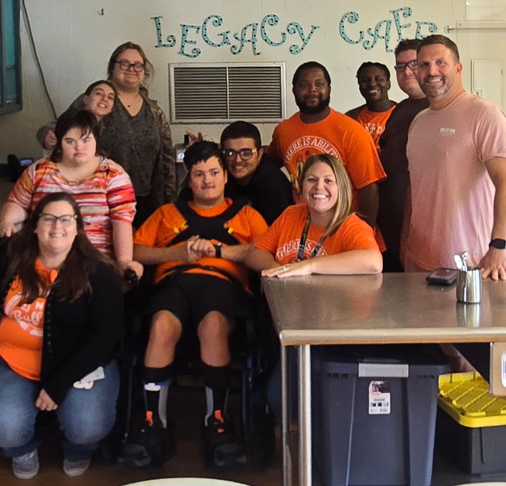 Students of LEgacy Cafe with Dave from Wild Ox. Everyone is wearing orange.