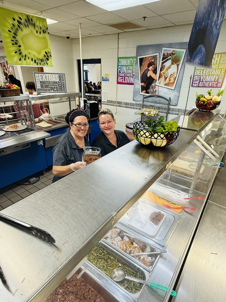 Cafeteria workers smiling with Chili! 