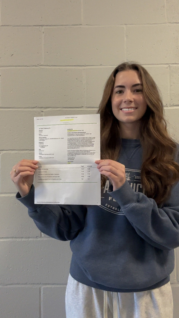 Alivia Whaley smiling with her 100% score on her CNAs