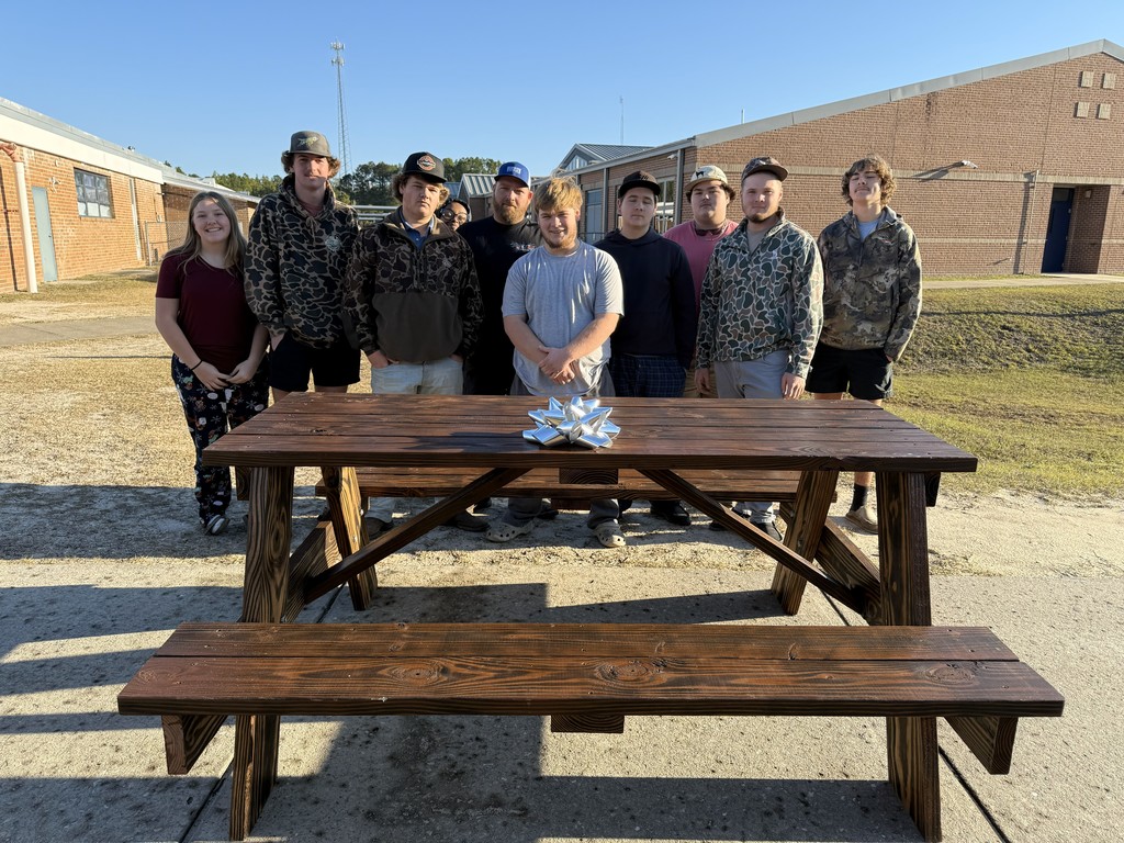 Carpentry Students in front of their picnic table